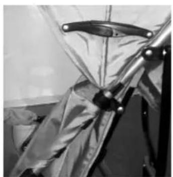 Close-up of a mechanical device with metallic blades and a handle, partially covered by fabric or insulation (no visible text or symbols)