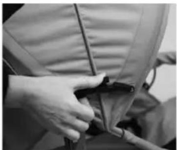 Close-up of hands adjusting a garment with a zipper (no visible text or symbols)