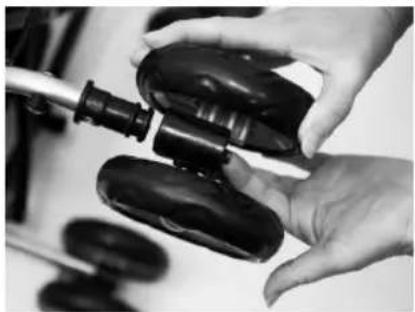Close-up of hands holding a black plastic device with a tool, no visible text or symbols