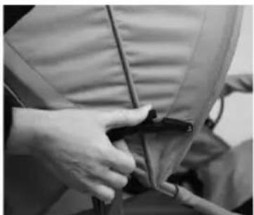 Close-up of hands adjusting a garment with a zipper (no visible text or symbols)