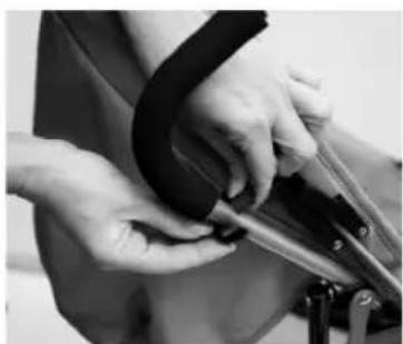 Close-up of hands using crimping scissors to adjust a black object (no visible text or symbols)