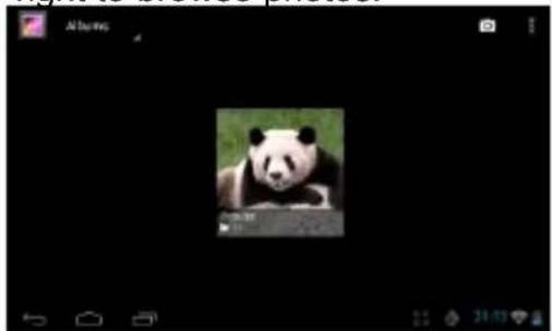 Black-and-white photo of a panda in a grassy field, no visible text or symbols