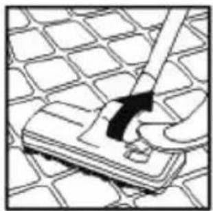 Illustration of a hand using a tool to clean or store floor tiles on a grid-patterned surface (no text or symbols)