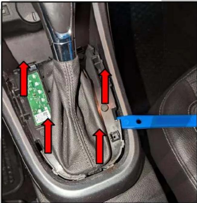 Car gear shift mechanism diagram with red arrows indicating movement and a blue tool interacting with the gear