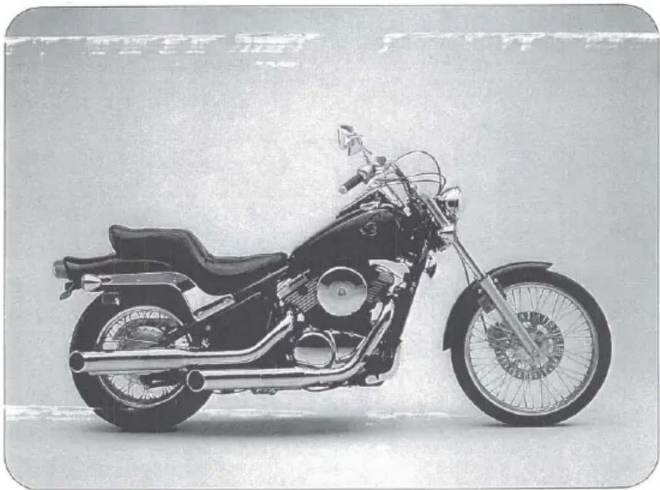 Side profile of a vintage motorcycle with visible engine and wheel (no text or symbols)