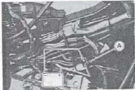 Black-and-white photo of a damaged electrical panel with visible wiring and components (no readable text or symbols)