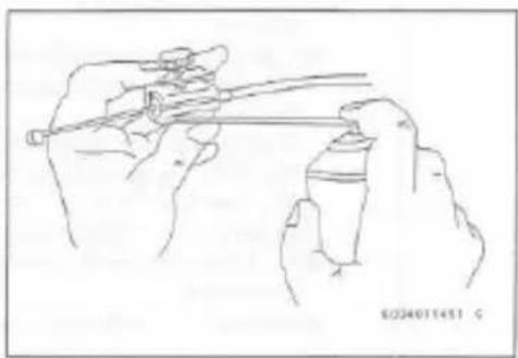 Line drawing of two hands holding a spray can and a container (no text or symbols)