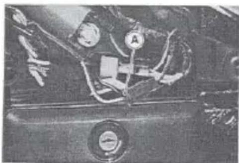 Close-up of a vehicle's front wheel assembly with visible components and no text or symbols