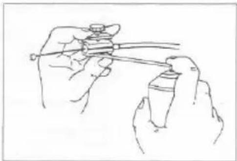 Line drawing of two hands holding a tool, one spraying liquid onto a cylindrical object (no text or symbols)