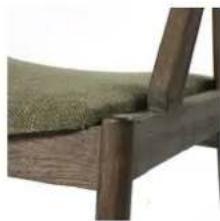 Close-up of a wooden armchair with a green cushioned seat (no text or symbols visible)