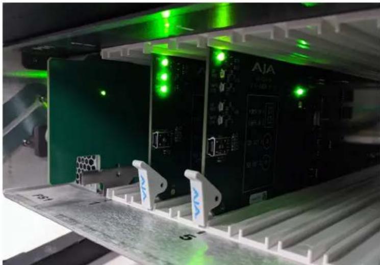 Interior view of an electronic device with green laser indicators and labeled panels (no readable text or symbols)