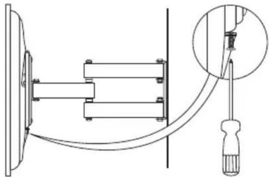 Technical line drawing of a mechanical assembly with a screwdriver inserted, showing no text or symbols.