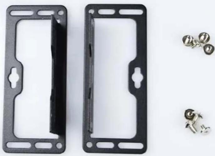 Two black plastic brake plates with mounting holes and a side panel, accompanied by four small metallic screws (no text or symbols visible)