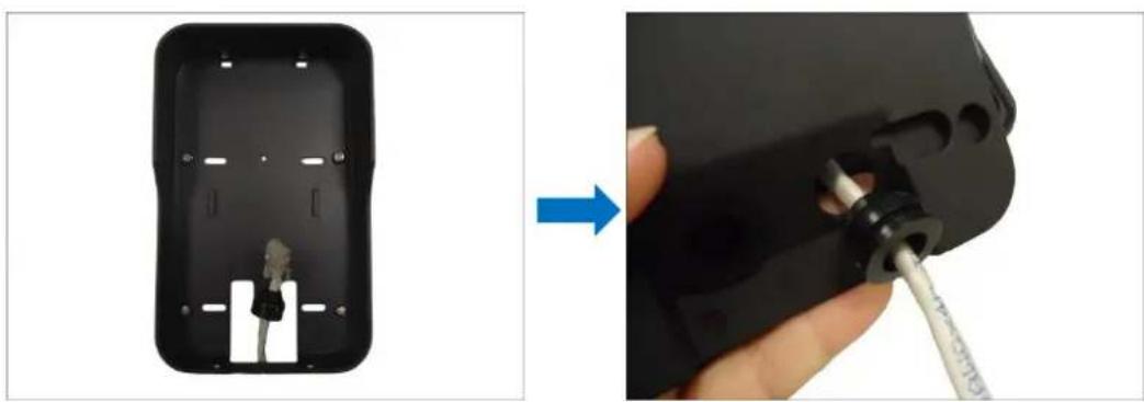 Close-up of a black remote control box with internal components being inserted, showing a hand holding a screwdriver (no text or symbols visible)