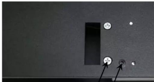Close-up of a black electronic component with two circular holes and a rectangular slot, no visible text or symbols.