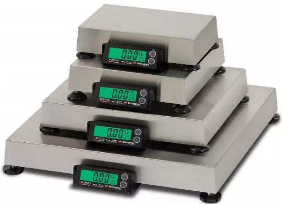 Four digital pressure balance scales with green and black buttons, no visible text or symbols on the scales.