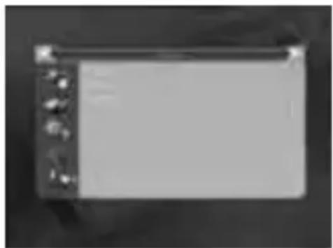 Exterior view of a rectangular electronic device with control knobs and buttons (no visible text or symbols)