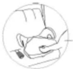 Simple line drawing of a hand holding a small object, enclosed in a circle (no text or symbols).