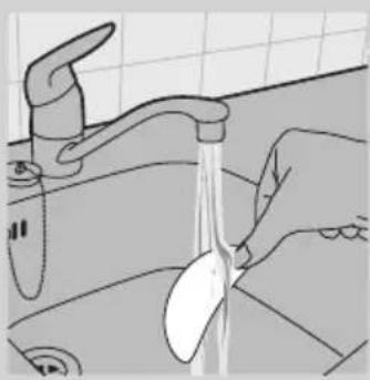 Line drawing of a hand washing a kitchen sink with a spoon, no text or symbols.