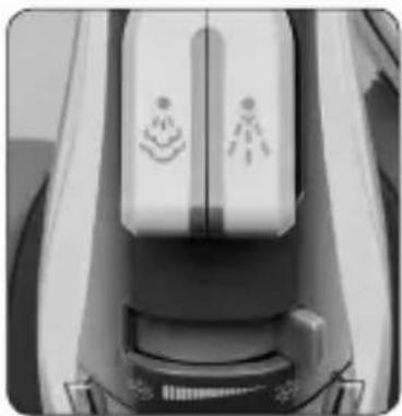 Close-up of a medical device with two white circular symbols on its side, no visible text or labels