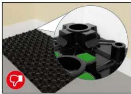 Close-up of a black plastic mechanical component with green accents, shown alongside an inset close-up of its internal structure (no text or symbols visible)
