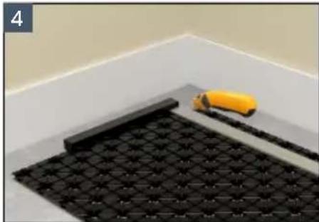 Interior view of a tiled floor with black tiles and a yellow tool, no visible text or symbols