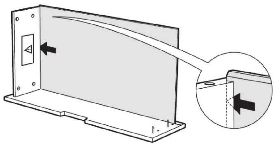 Technical diagram showing a device panel with an arrow pointing to a control panel, and a magnified inset highlighting the component's direction.