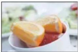 Close-up of sliced citrus fruits in a white bowl (no text or symbols visible)
