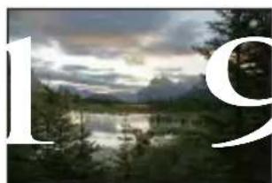 Scenic landscape with a lake, forested hills, and a cloudy sky (no text or symbols visible)