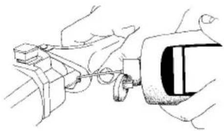 Line drawing of hands using a tool to adjust or install a mechanical component (no text or symbols present)