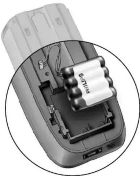 Close-up of a battery pack with a cylindrical component inserted, showing internal components and wiring (no text or symbols visible)