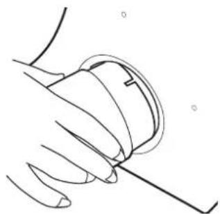 Line drawing of a hand holding a small object with a ruler, no text or symbols present