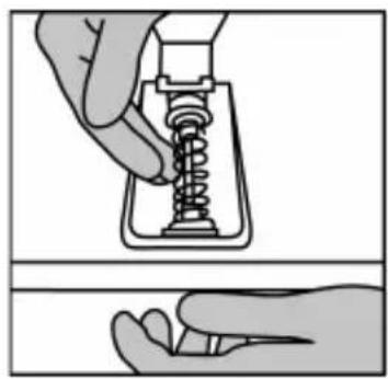Illustration of a hand holding a spring-loaded mechanical component, showing internal structure and assembly (no text or symbols).