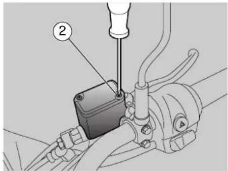 Technical diagram showing a mechanical assembly with labeled component 2 and a tool inserted into a housing.