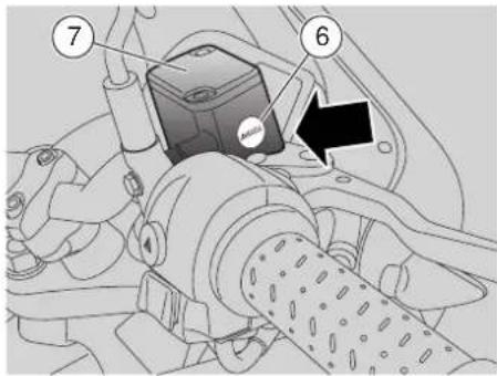 Technical diagram of a vehicle's internal components with numbered parts and an arrow indicating a specific location.