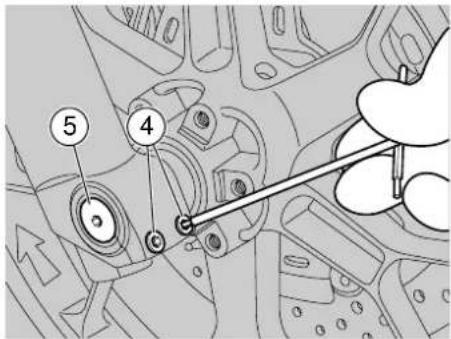 Technical diagram showing mechanical components with numbered parts and a hand holding a tool, likely illustrating assembly or inspection.