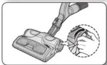 Illustration of a hand inserting a component into a vacuum cleaner (no text or symbols present)