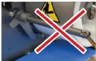 Safety warning sign with red X mark over industrial equipment background