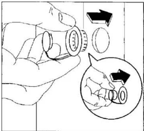 Diagram showing a hand holding a mechanical component with an inset illustrating the process of rotation or adjustment.