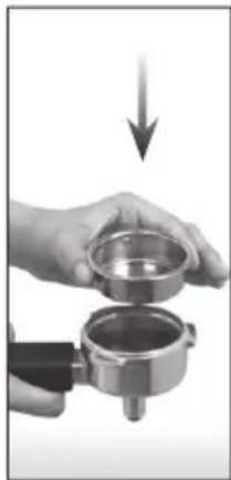 Close-up of a hand holding a small metal container with a downward arrow indicating compression or disassembly (no text or symbols visible)