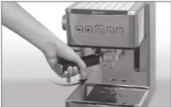 Hand using a standard espresso machine to press or adjust its volume (no visible text or symbols)
