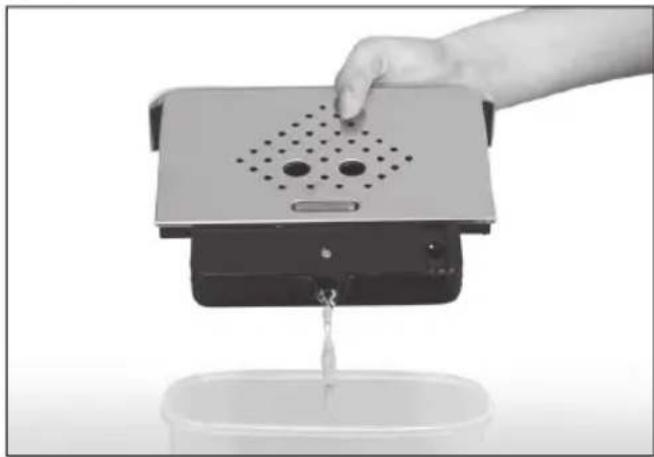 Hand pouring liquid into a small container with a perforated top device (no text or symbols visible)