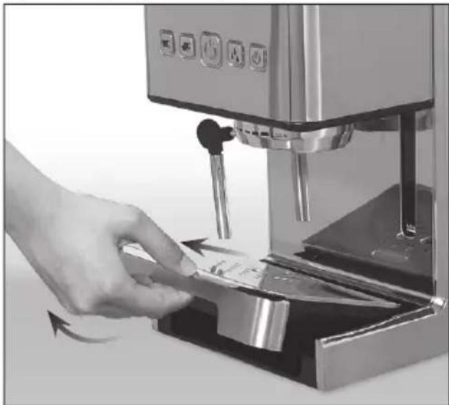 Hand inserting a card into a coffee machine (no visible text or symbols)