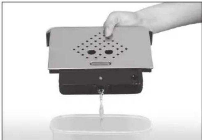 Hand pouring liquid into a small container with a digital device (no visible text or symbols)