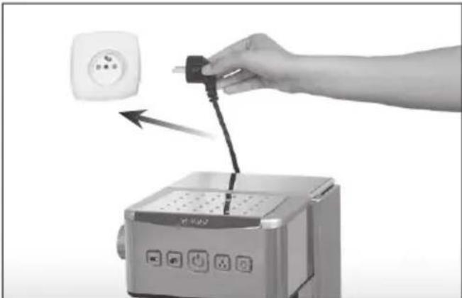 Hand inserting a plug into a microwave oven with a power outlet (no text or symbols visible)