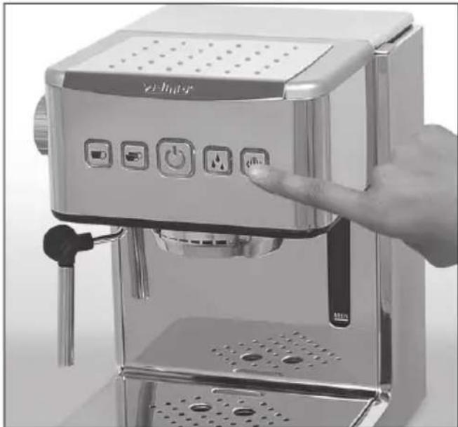 Close-up of a hand operating a Bruiser machine with control buttons and indicator lights (no visible text or symbols)