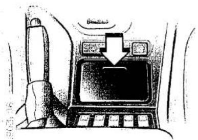 Diagram of a car interior showing a device with a downward arrow and 'Bened' label, likely indicating a directional change or movement.