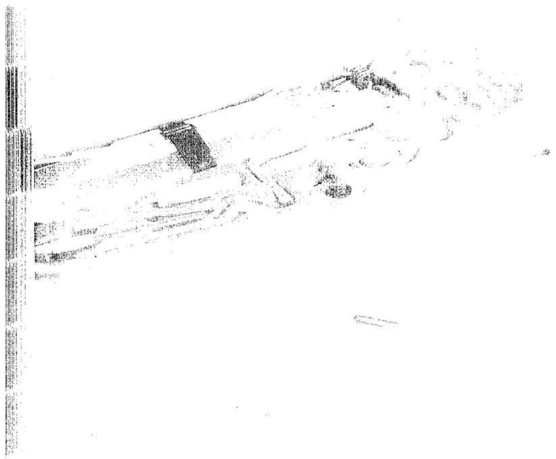Scanned document page with dense text and a small embedded image, likely a form or report section.