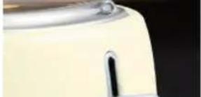 Close-up of a white kitchen blender with a black handle (no visible text or symbols)