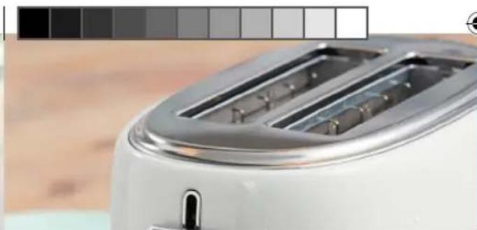 Close-up of a white toaster with metallic grille and side grilles (no visible text or symbols)
